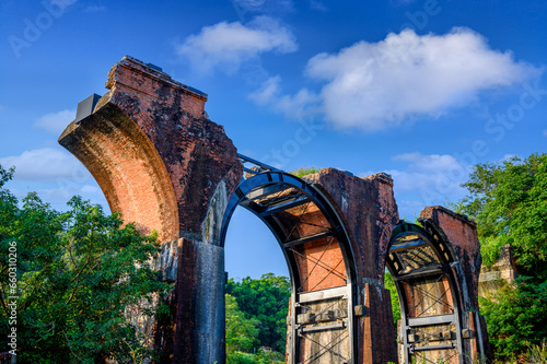 Red Brick arches at both ends are combined with a central steel truss. Longteng Broken Bridge is a historic roadside attraction in the rolling hills. photo