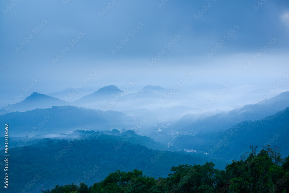 The mountain tops and villages in the valleys are clouded over. The view of Jinlong Mountain in the early morning, Nantou County. Taiwan
