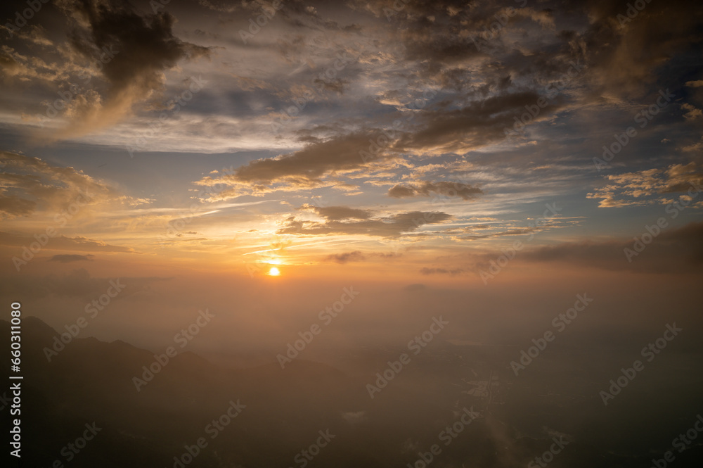 The sun rises behind the mountains. It illuminates the villages of the valley. The scenery along Alishan Highway. Chiayi County, Taiwan. The sun rises behind the mountains. It illuminates the villages of the valley. The scenery along Alishan Highway. Chiayi County, Taiwan.