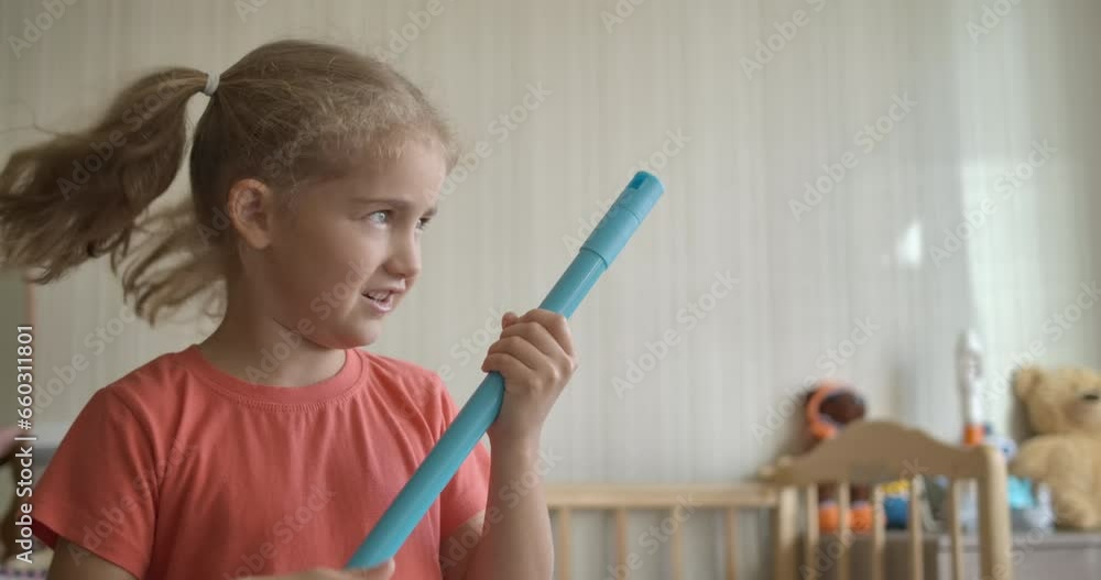 Little Fun Creative Girl Singing and Using Broom Handle as Microphone. Child Using Mop as Microphone While Singing in Domestic Room. Enjoying Spring Cleaning. Playful Creative Kid Dancing With Mop. Little Fun Creative Girl Singing and Using Broom Handle as Microphone. Child Using Mop as Microphone While Singing in Domestic Room. Enjoying Spring Cleaning. Playful Creative Kid Dancing With Mop.