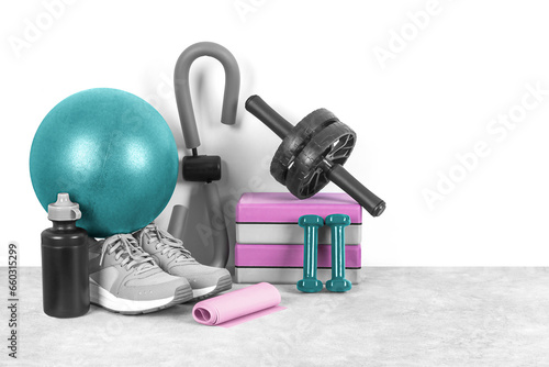 Different sports equipment on a gray background, front view, copy space. Home workout. Fitness and activity. 