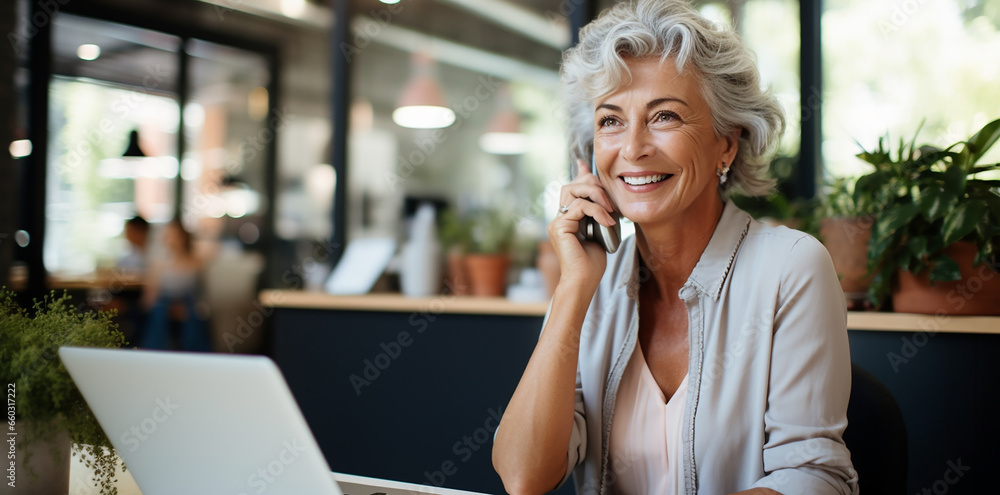 portrait of an l elderly woman with long grey and white hair, working with computer pc in office portrait of an l elderly woman with long grey and white hair, working with computer pc in office