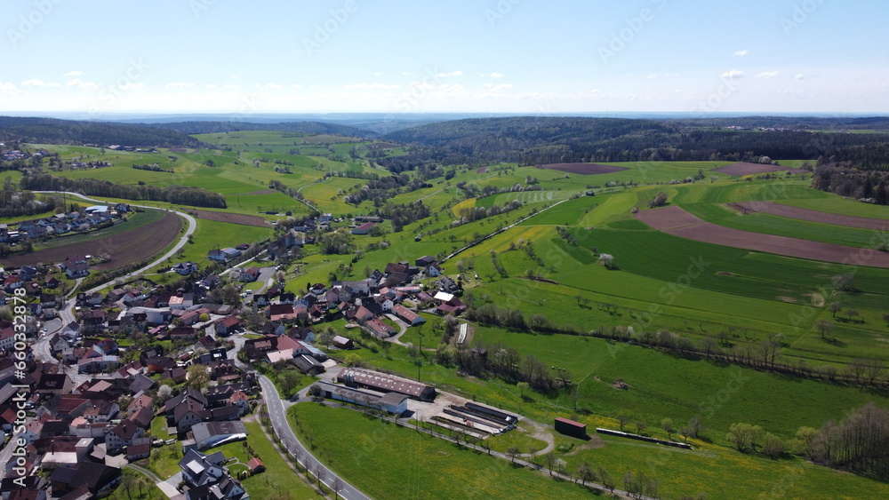 Drohnenaufnahme eines ländlichen Drofes der Rhön in Unterfranken Drohnenaufnahme eines ländlichen Drofes der Rhön in Unterfranken