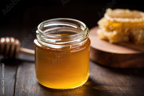 glass jar filled with raw, unfiltered honey