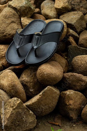 Black leather sandals, pictured outdoors. outdoor leather sandals. leather sandals