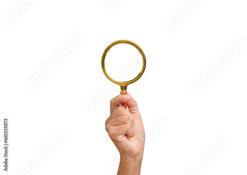 Close-up of hand holding a magnifying glass against a transparent background.