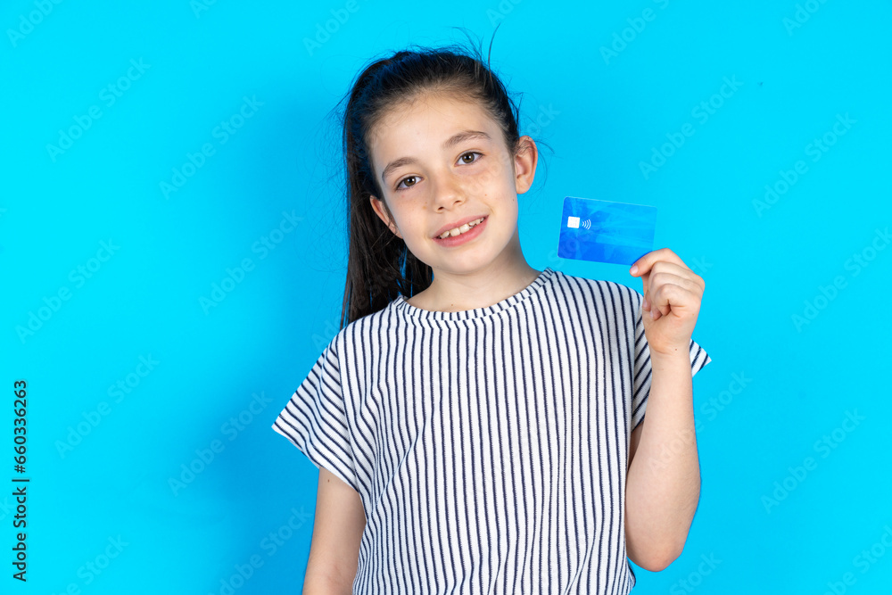 Close up photo of optimistic Beautiful caucasian kid girl hold card Close up photo of optimistic Beautiful caucasian kid girl hold card