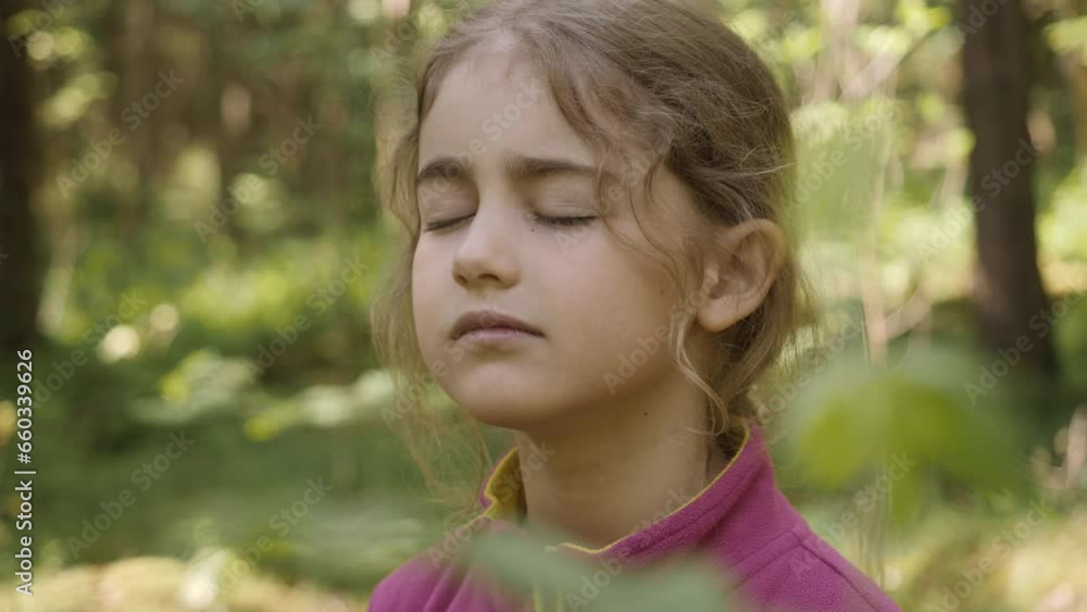 Portrait Child Girl Exhaling Fresh Air, Taking Deep Breath, Reducing Stress in Forest. Dreamy peaceful relaxed smiling kid girl breathing fresh air nature, tranquil caucasian child alone outdoors. Portrait Child Girl Exhaling Fresh Air, Taking Deep Breath, Reducing Stress in Forest. Dreamy peaceful relaxed smiling kid girl breathing fresh air nature, tranquil caucasian child alone outdoors.