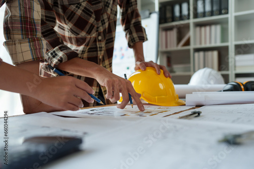 Engineers, designers and interior designers are finalizing the design of interiors by discussing selecting materials and colors to design rooms to present to clients.