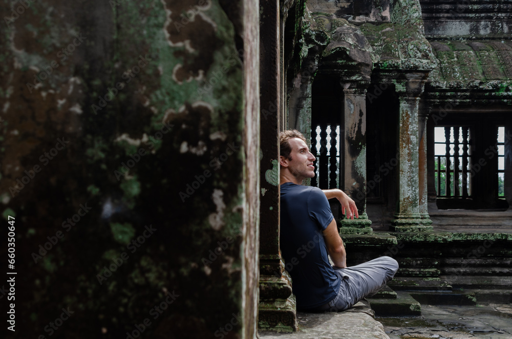 Caucasian Tourist Enjoying The Temples Of Angkor Wat In Cambodia Caucasian Tourist Enjoying The Temples Of Angkor Wat In Cambodia