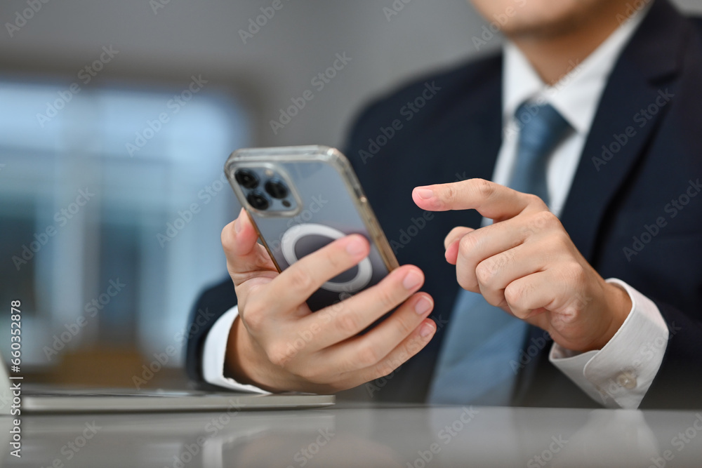 Young businessman texting message on smartphone. Communication, technology and business lifestyle concept Young businessman texting message on smartphone. Communication, technology and business lifestyle concept