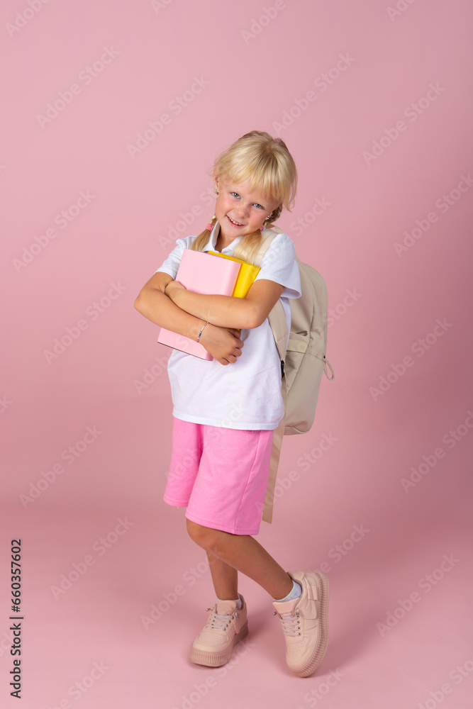 Girl with books in her hands and a backpack. Girl with books in her hands and a backpack.