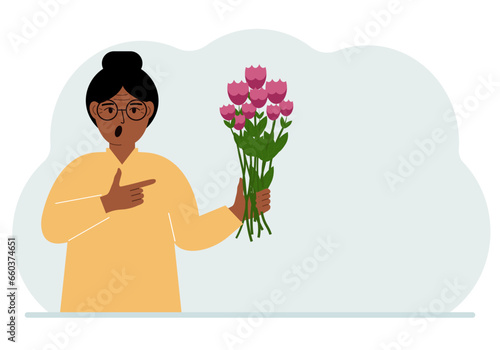 A woman is holding a large bouquet of flowers. The concept of a holiday, congratulations, romance or gift.