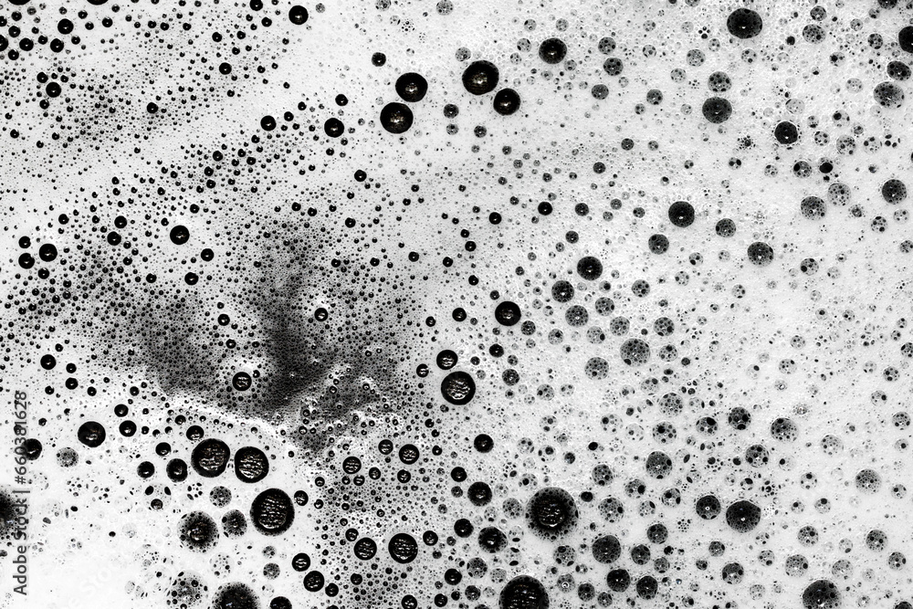 Soap bubbles texture. Black teflon frying pan cleaning. White suds pattern. Liquid detergent foam. Closeup shampoo bubbles. Washing dishes background. - obrazy, fototapety, plakaty 