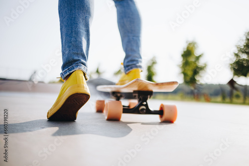 Legs of a skater girl on the skateboard at the skate park in the city. skateboarding and fun concept