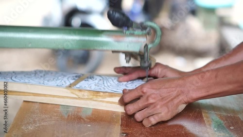 The initial process of making traditional Javanese Gebyok is made from whole wood which is cut and carved using simple tools by wood craftsmen. photo