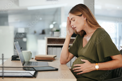 Pregnant, woman and headache in office with tired, burnout and relax with eyes closed at desk or table. Person, pregnancy or hand on stomach for risk, anxiety or stress at professional company or job
