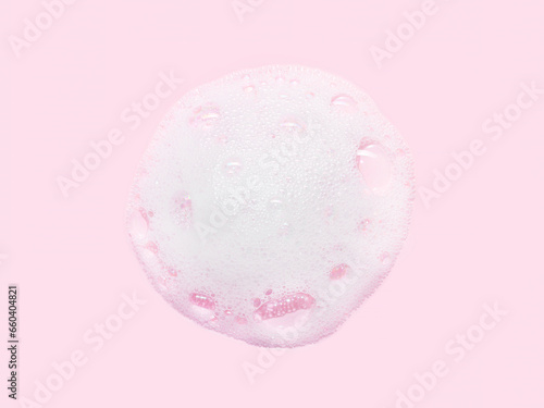 Skincare cleanser foam texture with bubbles isolated on pink background. Soap shampoo face wash cleansing musse product sample