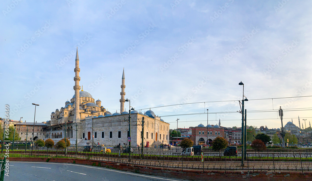 Yeni Cami Mosque or New Mosque in Istanbul at sunset, soft light effect. Panoramic view of the muslim architecture in Turkey capital, district of Sultanahmet in old town.