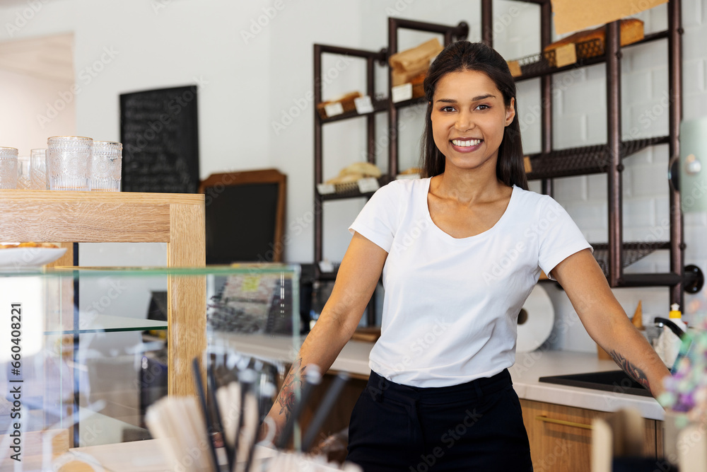 Portrait of smiling small business owner standing in bakery pastry shop Portrait of smiling small business owner standing in bakery pastry shop