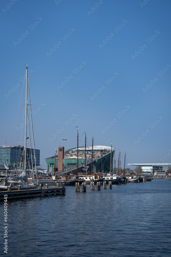 Amsterdam, Netherlands - March 29, 2022: NEMO science center of Amsterdam. Maritime museum near Amsterdam Centraal Station. Futuristic building exterior at a sunny day in summer.