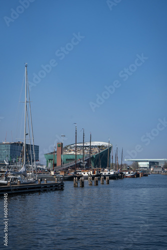 Amsterdam, Netherlands - March 29, 2022: NEMO science center of Amsterdam. Maritime museum near Amsterdam Centraal Station. Futuristic building exterior at a sunny day in summer.