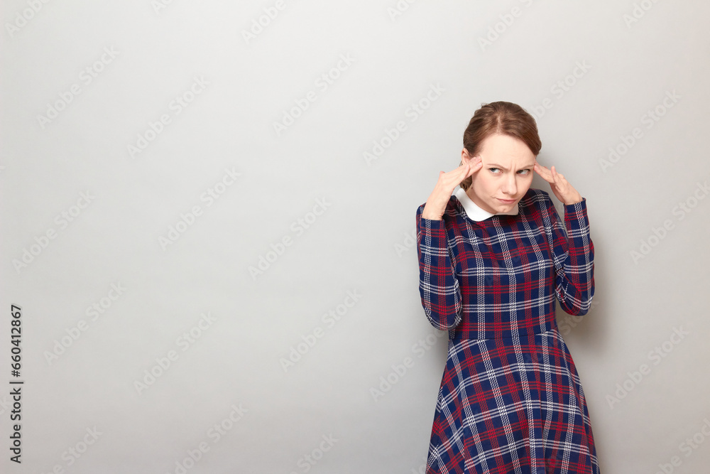 Portrait of serious focused young woman touching temples with fingers Portrait of serious focused young woman touching temples with fingers