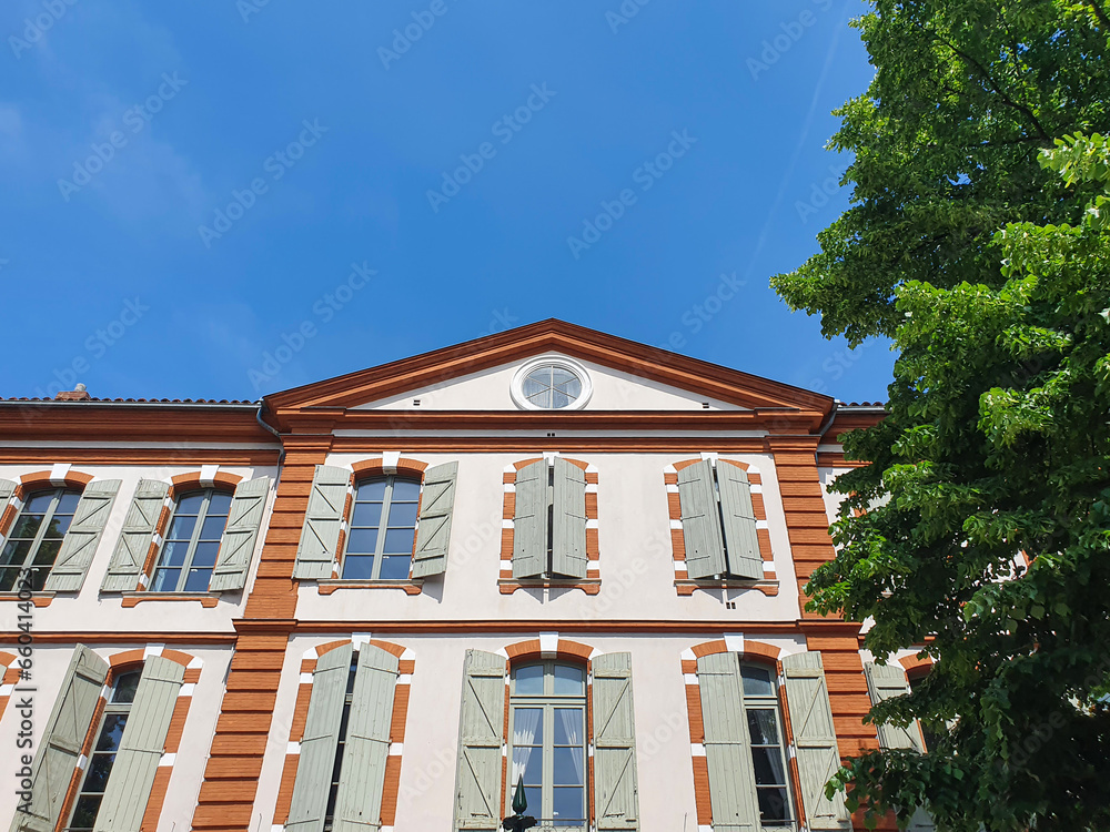 Fototapeta premium low angle view of beautiful building against blue sky in Toulouse, France