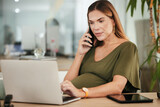 Phone call conversation, office laptop and pregnant woman online, typing and reading website research, insight or report. Cellphone, pregnancy and maternity person check schedule or consultation info