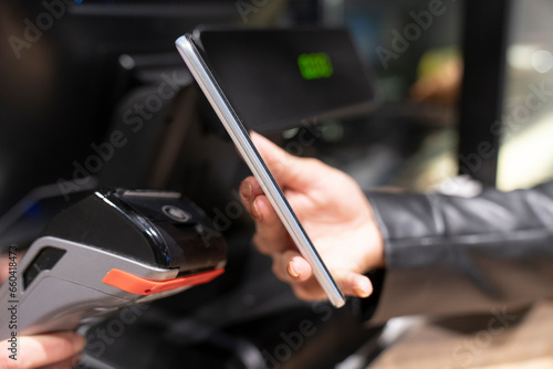 Cropped Hand Of Customer Using Smart Watch For Contactless Payment To Owner At Cafe