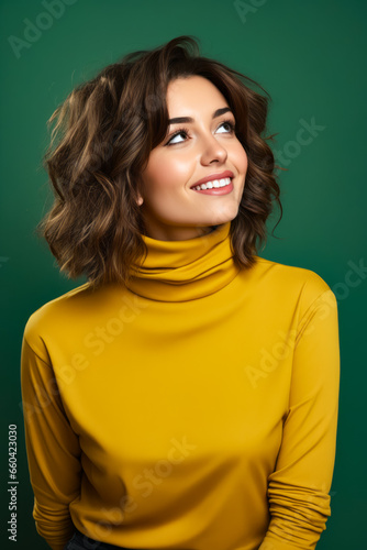 Woman with smile on her face and yellow turtle neck top.