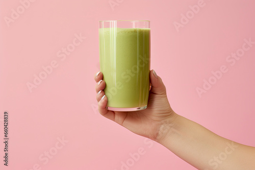 Drinking green healthy smoothie concept. Close up of woman hands with green juice. Hand holding a glass of green smoothie. Healthy vegan breakfast. Clean eating, vegetarian, weight loss food concept.