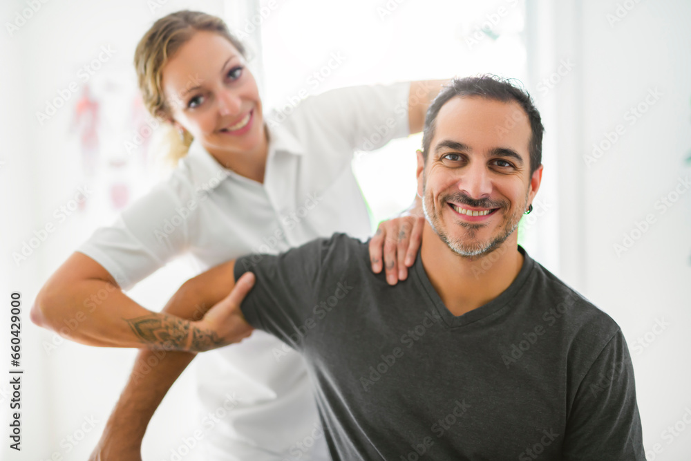 Fototapeta premium Modern rehabilitation physiotherapy woman with man client