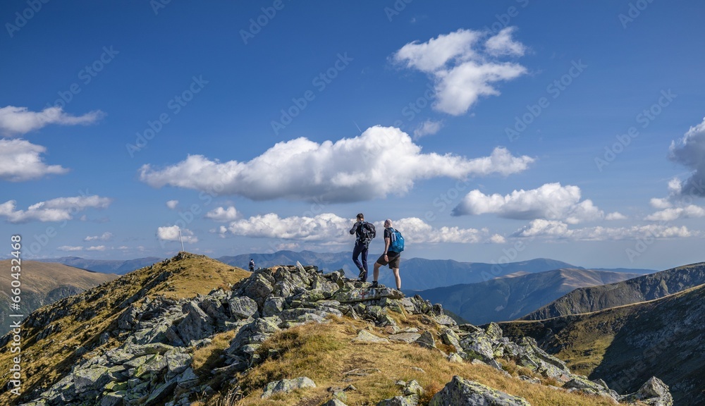 Scenic view of two men hiking in Fagaras Mountains, Romania