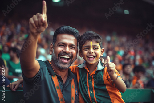 Indian man watching match with his son at stadium