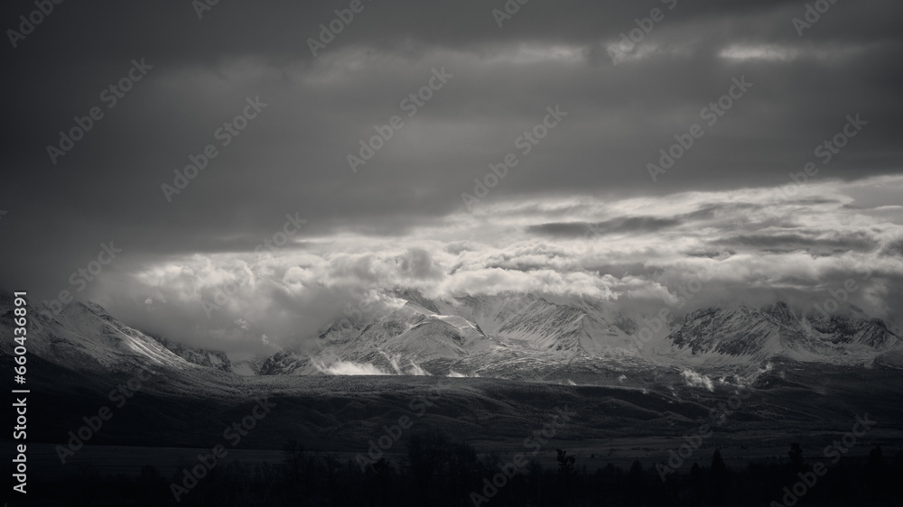 Black and white image of snow-capped mountains.