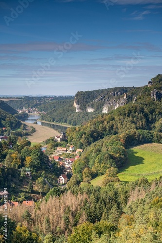 View of a picturesque valley surrounded by a lush, forested landscape