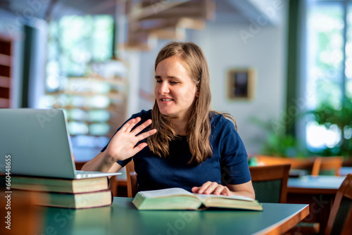 Wallpaper Mural A visually impaired woman with her notebook sitting and studying in the university library Torontodigital.ca