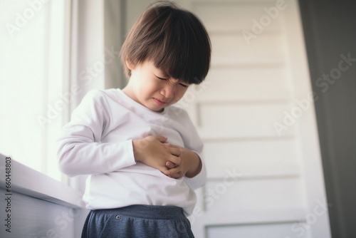asian child have stomach ache photo