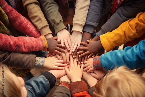 many child hands touch together in a circle photo