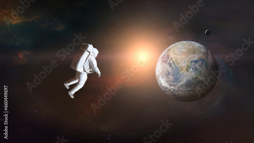 Cosmonaut in outer space on Earth background with sunlight. Elements of this image furnished by NASA.