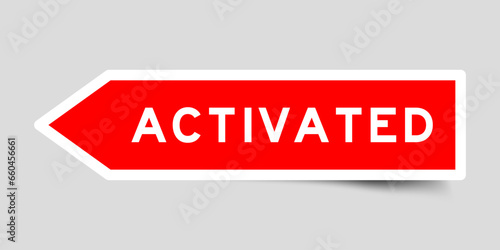 Red color arrow shape sticker label with word activated on gray background