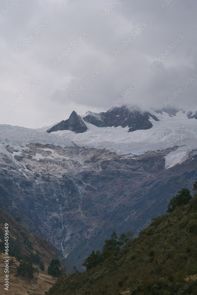 The valley of Jancapampa, Peru with the spectacular view of the peaks and glacier Pucajirca and several streams flowing down into the river. Vertical Image The valley of Jancapampa, Peru with the spectacular view of the peaks and glacier Pucajirca and several streams flowing down into the river. Vertical Image