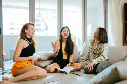A group of female friends sitting at home having fun talking, businesswoman.