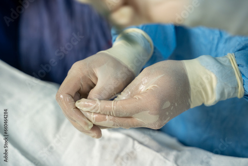 your hand with the surgical glove