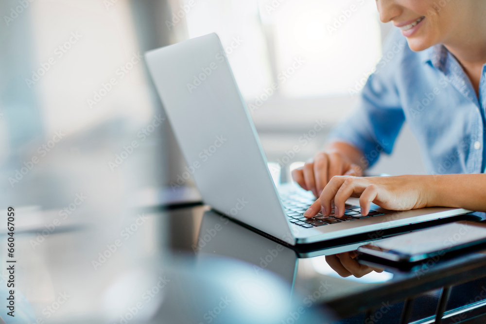 Close up of a woman working on the laptop at home Close up of a woman working on the laptop at home
