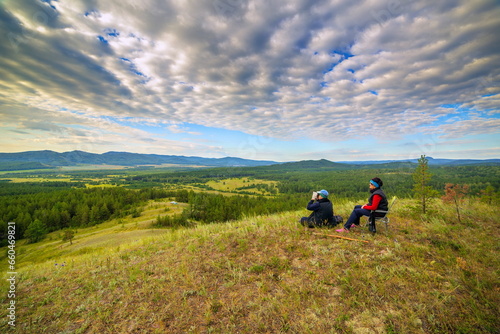 beautiful mature couple on the slope of the mountain of the southern Urals on a summer day