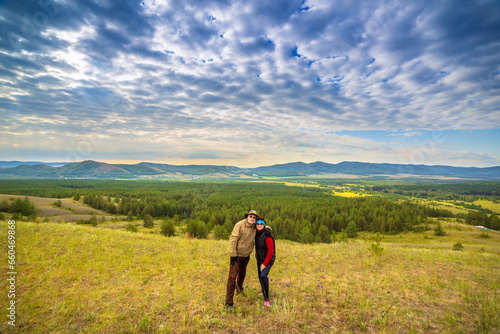 beautiful mature couple on the slope of the mountain of the southern Urals on a summer day © tramp51
