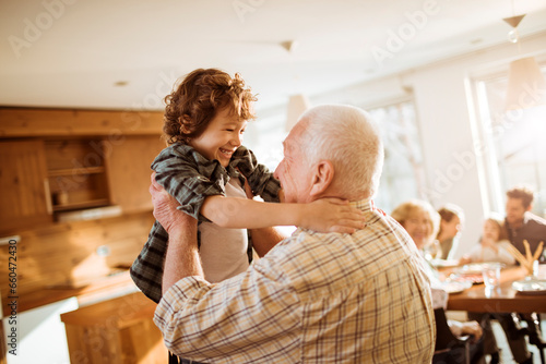 Grandfather embracing his grandson at home