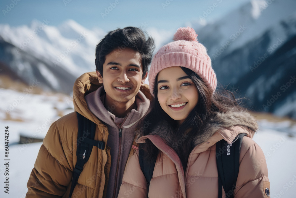 Young couple in warm wear, enjoying vacation at cold mountain Young couple in warm wear, enjoying vacation at cold mountain